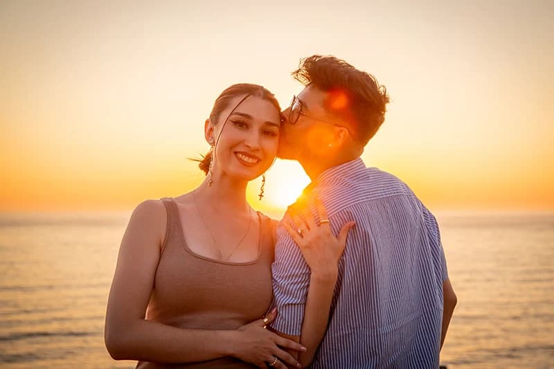 Couple embracing on the beach at sunset