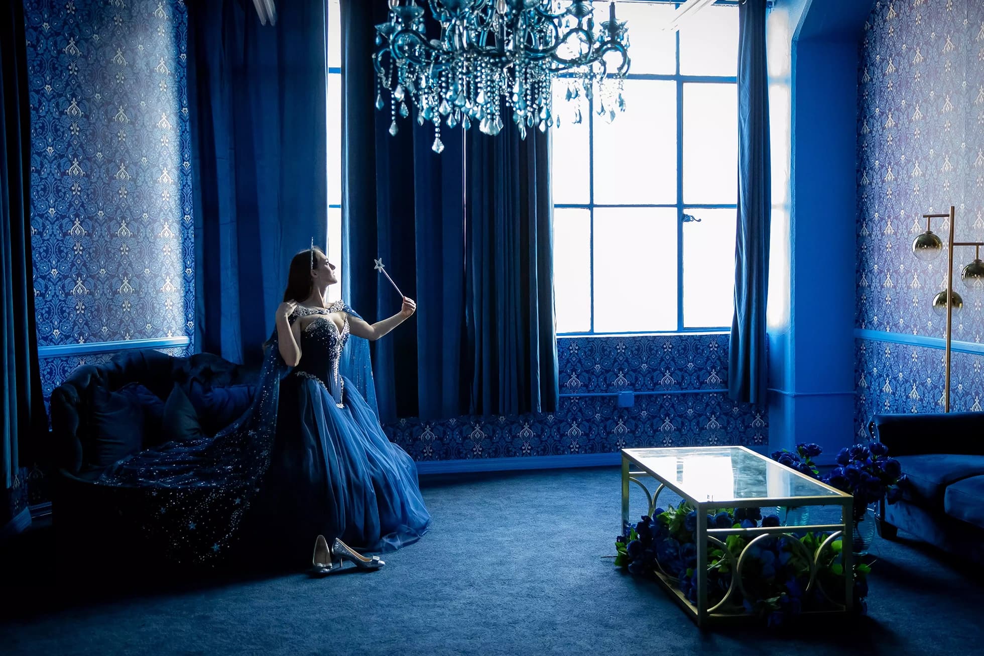 Quinceañera portrait session in an elegant blue chandelier suite