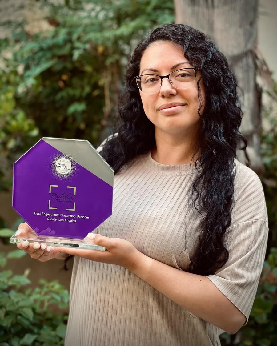 Marlene Vafai holding the 2022 Global Wedding Awards trophy for Best Engagement Photoshoot Provider, Greater Los Angeles