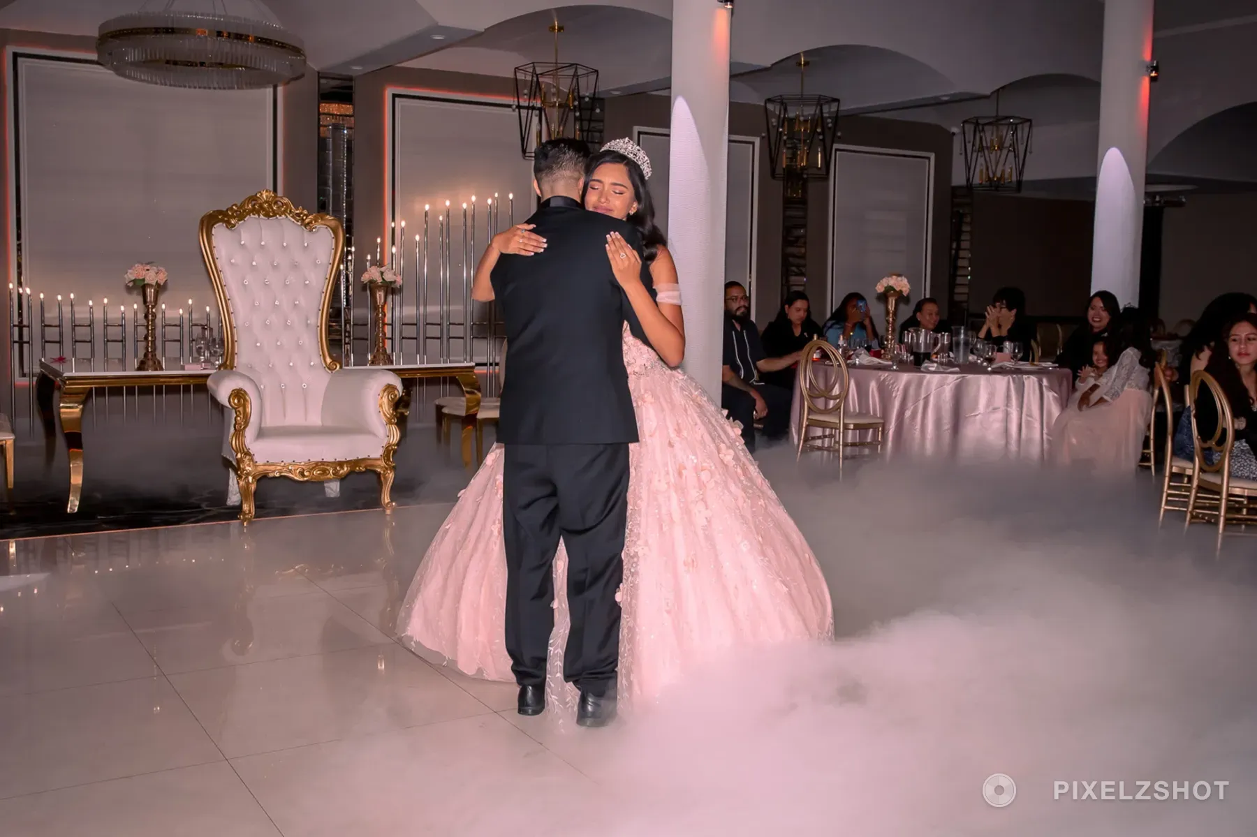 Lalaine with her eyes closed on her father's shoulder during their dance, low fog covering the floor around them